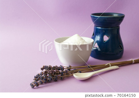 Lavander spa, salty scrub in ceramic bowl, blue aroma lamp. 70164150