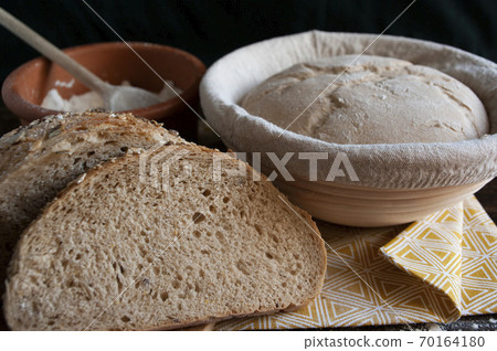 sourdough dough in proofing basket , whole wheat recipe. Rye flour bread slices. Home baked seed bread. sourdough dough in proofing basket , whole wheat recipe. Rye flour bread slices. Home baked seed bread. 70164180