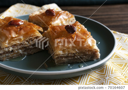 Sweet walnuts dessert, pastry dough, honey, turkish baklava. Home made bakery. Close up. Sweet walnuts dessert, pastry dough, honey, turkish baklava. Home made bakery. Close up. 70164607