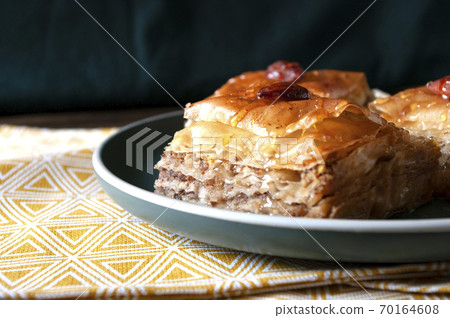 Sweet baklava, turkish food, dessert with walnuts and sugar syrup. Home made bakery. Sweet baklava, turkish food, dessert with walnuts and sugar syrup. Home made bakery. 70164608