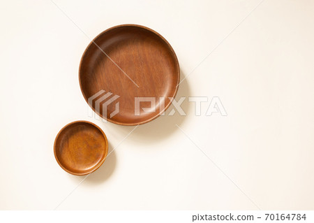Empty wooden plates, top view. Craft round dishes on light beige background with copy space. Template for menu or recipe 70164784