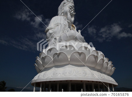 A giant Buddha statue with a Buddhist eye engraved on the palm of the hand in Chiang Rai Watt Phi Raccoon, Thailand 70165876
