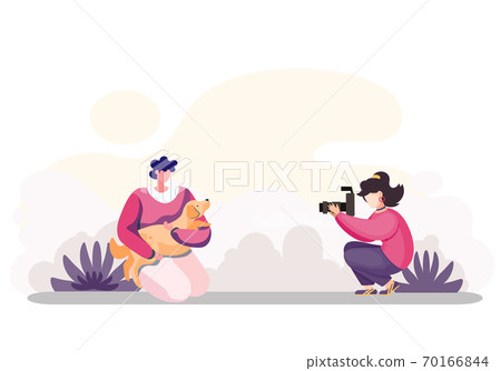 The photographer takes a picture of happy young woman holding and hugging a cute puppy outdoors The photographer takes a picture of happy young woman holding and hugging a cute puppy outdoors 70166844