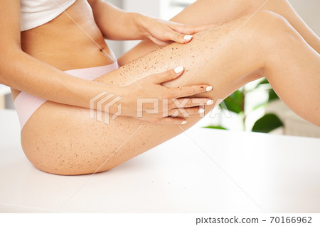 Closeup woman legs with coffee massage scrub 70166962