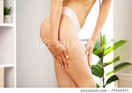 Closeup woman legs with coffee massage scrub 70166971