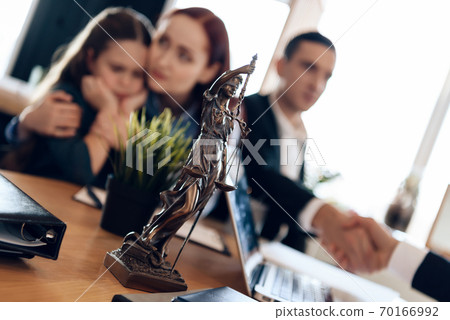 Bronze statue stands on table at lawyer. Bronze statue stands on table at lawyer. 70166992