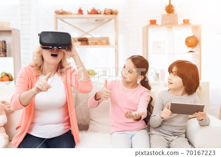 Surprised adult woman in virtual reality glasses. Surprised adult woman in virtual reality glasses. 70167223