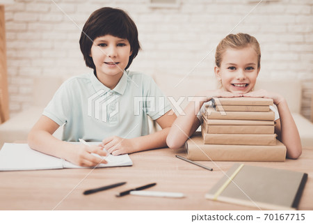 Brother and sister are writing and smile. 70167715