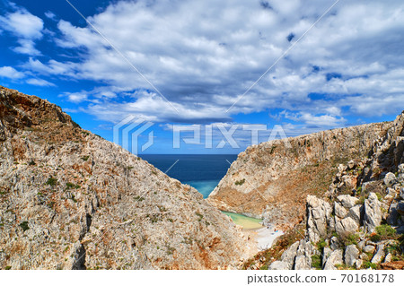 Rocky red cliffs, blue sea, clear blue sky and beautiful sky. Stefanou beach, Seitan Limania, Akrotiri peninsula, Chania region, Crete island, Greece 70168178