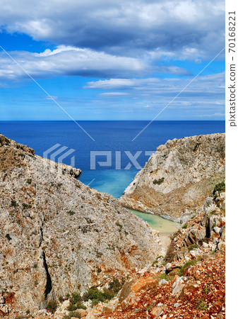 Vertical view of z-shaped cove on sunny day. Great blue sky and beautiful clouds. Seitan Limania, Akrotiri peninsula, Chania, Crete island, Greece Vertical view of z-shaped cove on sunny day. Great blue sky and beautiful clouds. Seitan Limania, Akrotiri peninsula, Chania, Crete island, Greece 70168221