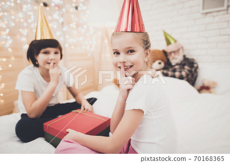 Children opening present while grandpa is sleeping Children opening present while grandpa is sleeping 70168365