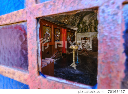Interior of Orthodox cave church of St John the Hermit in abandoned Katholiko monastery, Crete, Greece. Shot through open window. Selective focus. 70168437