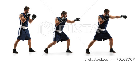 Young boxer against white studio background in motion of step-to-step kicking 70168707