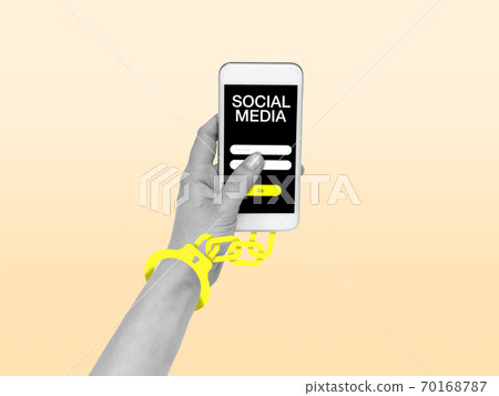 Hand using smartphone, device on top view. Addicted, wired with chain to social media on the screen 70168787