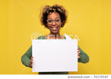 Happy african american young woman holding blank speech bubble Happy african american young woman holding blank speech bubble 70170597