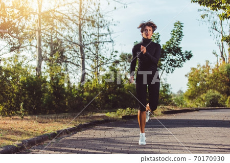 beautiful girl running in the park beautiful girl running in the park 70170930