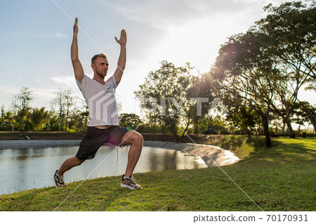 man doing warm-up in the park man doing warm-up in the park 70170931