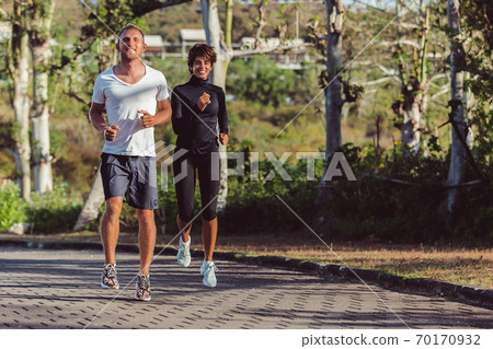 a guy with a girl doing a warm-up in the park a guy with a girl doing a warm-up in the park 70170932