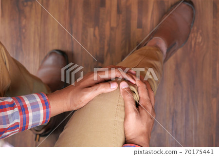 Close up on man suffering knee joint pain Close up on man suffering knee joint pain 70175441