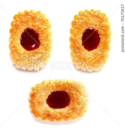 Three cookies with a blob of jam in the middle on a white background Three cookies with a blob of jam in the middle on a white background 70175617