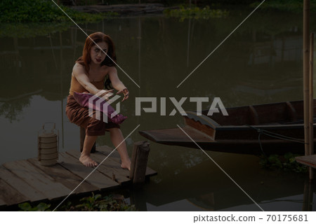 Ancient Thai ghosts in traditional costumes that appear in history and have The uniqueness of traditional Thai dress sit waiti ng for her husband at the pier at night. 70175681