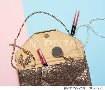 open gold clutch and dropped bracelets with shiny stones, cosmetics open gold clutch and dropped bracelets with shiny stones, cosmetics 70176538