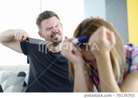 Angry husband threatens to stab his wife with pregnancy test in apartment Angry husband threatens to stab his wife with pregnancy test in apartment 70176703