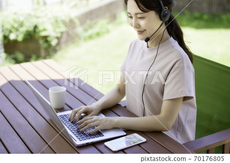 Young woman doing telework in the garden 70176805
