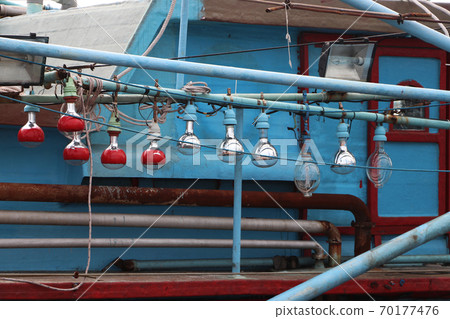 Hanging light bulb on the fishing boat. 70177476