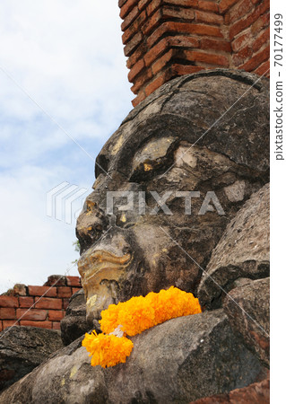 The ruins of stone Buddha pile together in the ruins and ancient church at Wat Worachet temple 70177499