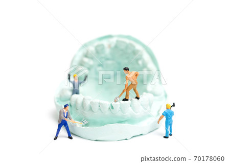 Miniature Worker team is filing fake teeth Miniature Worker team is filing fake teeth 70178060