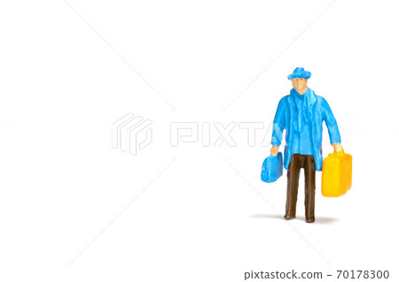 Miniature people ; Traveler holding a handbag on white background Miniature people ; Traveler holding a handbag on white background 70178300