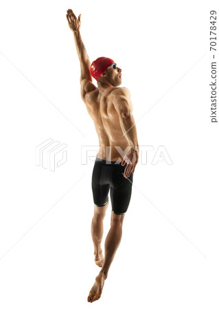 Caucasian professional sportsman, swimmer training isolated on white studio background Caucasian professional sportsman, swimmer training isolated on white studio background 70178429
