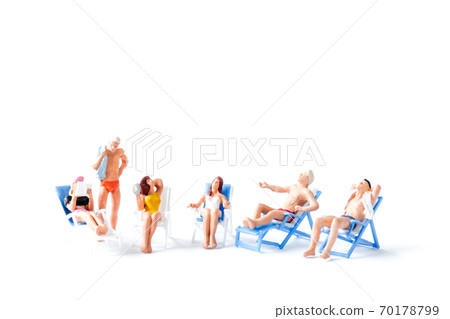 Miniature people sunbathing on deck chairs on white background , Summer time concept Miniature people sunbathing on deck chairs on white background , Summer time concept 70178799