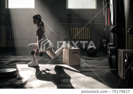 Sportive Female Squat With Dumbbell . 70179637