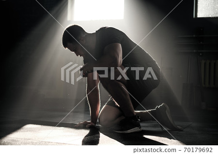 Silhouette of Man at Dark Gym . Silhouette of Man at Dark Gym . 70179692