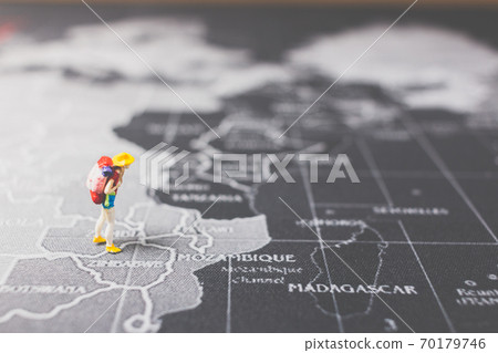 Miniature people backpacker walking on world map Miniature people backpacker walking on world map 70179746