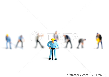 Miniature people worker holding tool on white bacckground, construction concept Miniature people worker holding tool on white bacckground, construction concept 70179795