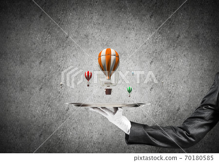 Hand of waitress presenting balloons on tray. 70180585