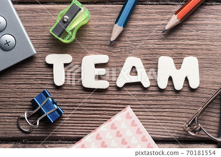 Team word on wooden table and office stationary around Team word on wooden table and office stationary around 70181554