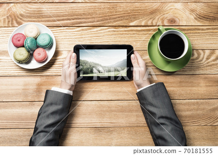 Businesswoman having coffee break Businesswoman having coffee break 70181555