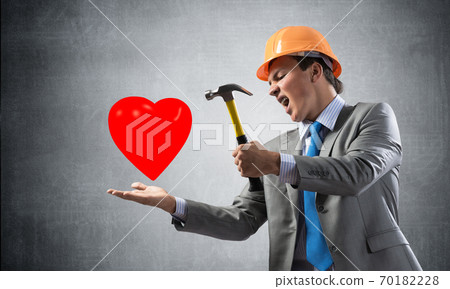 Furious businessman going to crash red heart 70182228
