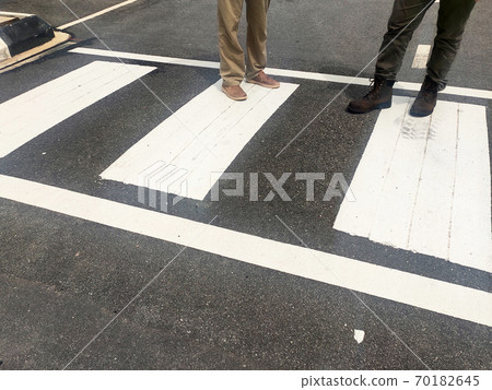 Zebra crossing for pedestrians on the road. Made of thermoplastic material and has light-reflective particles. Provides safety advantages to pedestrians. 70182645