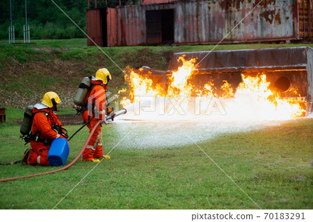 Firefighters spraying water to put out a brutal fire on the truck. 70183291