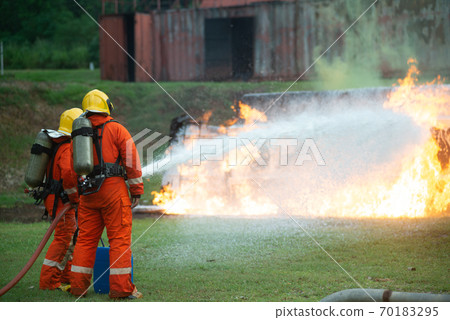 Firefighters spraying water to put out a brutal fire on the truck. 70183295