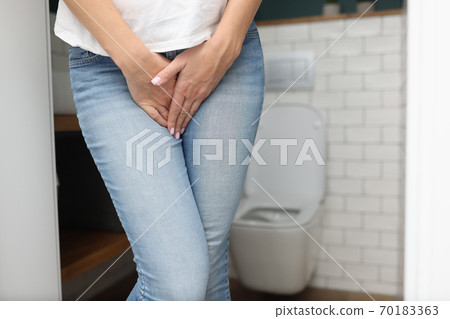 Female hands between legs in jeans close-up Female hands between legs in jeans close-up 70183363
