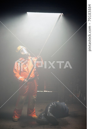 Firefighters are helping people in a burning and smoky building 70183884