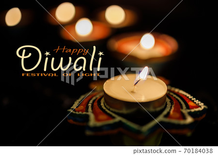 Happy Diwali day. Colorful traditional oil lamp diya on dark background. 70184038
