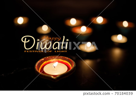 Happy Diwali day. Colorful traditional oil lamp diya on dark background. 70184039