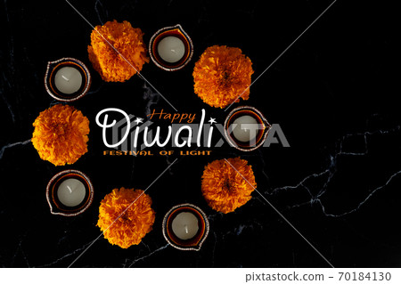 Happy Diwali day. Colorful traditional oil lamp diya on dark background. Happy Diwali day. Colorful traditional oil lamp diya on dark background. 70184130